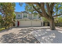 Charming two-story home featuring a brick driveway and mature landscaping, including a large shade tree at 1008 S Armenia Ave # A, Tampa, FL 33629