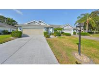 Charming single-story home with well-maintained landscaping and a spacious two-car garage at 1016 Mcdaniel St, Sun City Center, FL 33573