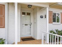 Inviting front entrance of white brick home with tiled porch and well-kept garden at 1666 S Lake Ave # 1, Clearwater, FL 33756