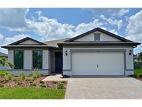 Charming single-Gathering home with a two-car garage, manicured lawn, and beautiful curb appeal at 2541 Charter Oak Dr, North Port, FL 34289