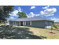 Charming single-story home featuring a lush lawn, complemented by mature trees and a serene setting at 3908 N Forbes Rd, Plant City, FL 33565