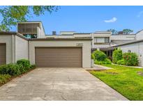 Charming townhome featuring a two-car garage, well-maintained landscaping, and a spacious driveway at 4212 Fairway Cir, Tampa, FL 33618