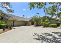 Spacious home featuring a large driveway, mature trees, and a well-maintained exterior at 5335 Sand Crane Ct, Wesley Chapel, FL 33543