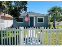 Charming single-story home with a well-manicured lawn and a classic white picket fence at 6401 30Th N Way, St Petersburg, FL 33702