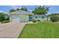Charming single Gathering home with well-maintained lawn, walkway and inviting curb appeal at 7542 20Th N St, St Petersburg, FL 33702