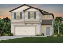 Two-story home featuring blue shutters, neutral siding, and a two-car garage, set against a twilight sky at 9959 Trellis Vine Way, Parrish, FL 34219