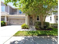 Charming two-story home featuring a well-manicured lawn and an attached two-car garage at 14616 Rocky Brook Dr, Tampa, FL 33625