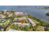 Aerial view of community with beautiful landscaping and waterfront views of the bay at 2700 Bayshore Blvd # 542, Dunedin, FL 34698