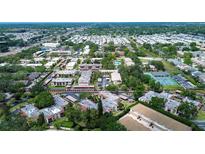 Expansive aerial view showcasing the property's landscaping, tennis courts, and surrounding neighborhood at 2971 Estancia Blvd # 328, Clearwater, FL 33761
