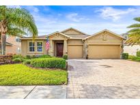 Beautiful single-Gathering home featuring a three-car garage and well-manicured landscaping at 3204 Mapleridge Dr, Lutz, FL 33558