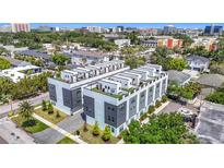 Modern townhome building featuring rooftop terraces, green space, and contemporary design in an urban setting at 4215 W North A St # 3, Tampa, FL 33609