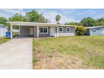 Charming single-story home featuring a covered carport and a well-maintained front yard at 5111 Eldorado Dr, Tampa, FL 33615