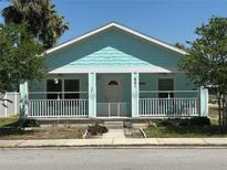 Charming single-story home with a quaint front porch and beautiful blue exterior at 641 N Garden Ave, Clearwater, FL 33755