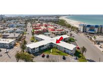 Overhead shot of condos near a sandy beach with turquoise waters at 7050 Sunset Way # 22, St Pete Beach, FL 33706