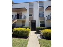 Two-story condo with gated entry, manicured bushes and neutral color scheme for a contemporary look at 107 Caldwell Dr # 178M, Brandon, FL 33510