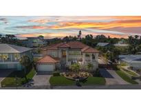 Stunning home with a red tile roof, a manicured lawn, and inviting outdoor living spaces at 107 Sunset Dr, Nokomis, FL 34275