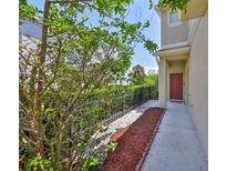 Inviting townhome entrance with well-maintained landscaping and a charming red front door at 11029 Winter Crest Dr Dr, Riverview, FL 33569