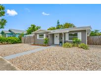 Charming single-story home with gray exterior, white trim, and fresh rock landscaping at 1120 45Th N St, St Petersburg, FL 33713