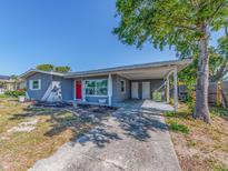 Charming one-story home with covered parking, red door, and freshly painted exterior at 11397 122Nd Ave, Largo, FL 33778