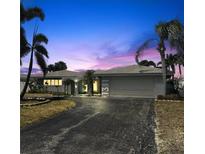 Charming single-story home with a two-car garage, mature landscaping, and a well-maintained driveway at 1311 Sea Gull S Dr, St Petersburg, FL 33707