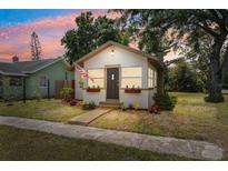 Charming single-story home featuring a well-kept lawn and an inviting front entrance with a patriotic American flag at 1601 54Th S St, Gulfport, FL 33707