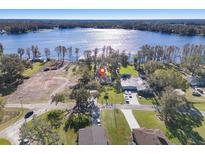 Expansive aerial view showcases the property's location near a beautiful lake and lush greenery at 21918 Shamu Dr, Land O Lakes, FL 34639