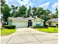 Charming single-story home showcasing lush landscaping, a two-car garage, and a welcoming tiled roof at 2776 Golf Lake Dr # 1, Plant City, FL 33566