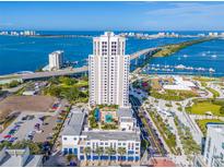 Stunning aerial view of a high-rise building with beautiful waterfront and bridge views on a sunny day at 331 Cleveland St # 1202, Clearwater, FL 33755