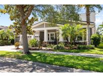Charming single-story home with a well-manicured lawn, mature landscaping, and inviting front porch at 5313 Sanderling Ridge Dr, Lithia, FL 33547