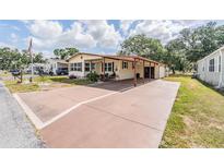 Inviting single-story home boasts a covered carport and well-maintained front yard at 5524 Betmar Dr, Zephyrhills, FL 33542