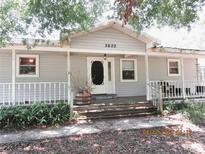 Inviting single-story home featuring a charming front porch and well-maintained landscaping at 5602 N Dormany Rd, Plant City, FL 33565