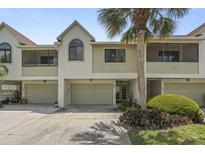 Charming two-story townhome with a well-manicured lawn and a one-car garage at 621 Duchess Blvd, Dunedin, FL 34698