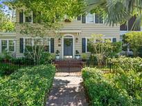 Charming two-story home with a brick walkway and meticulously landscaped front yard at 125 29Th N St, St Petersburg, FL 33713