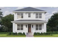 Charming two-story home featuring a classic white exterior, inviting front porch, and beautifully manicured landscaping at 1521 21St N Ave, St Petersburg, FL 33704