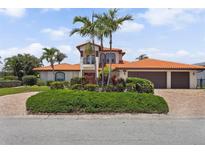 Stunning home with a red tile roof, lush landscaping, and a three-car garage at 1939 Hawaii Ne Ave, St Petersburg, FL 33703