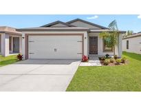 Charming single-Gathering home with a two-car garage, front lawn, and modern design at 2024 Waterfall Dr, Spring Hill, FL 34608