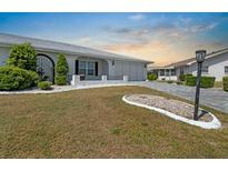 Charming home featuring a well-manicured lawn and a two-car garage at 204 Cactusflower Ln, Sun City Center, FL 33573