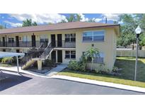 Charming two-story condo building with well-maintained landscaping and convenient carport parking for residents at 2501 Harn Blvd # H39, Clearwater, FL 33764