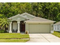 Charming single-story home with a well-maintained lawn and attached two-car garage at 25304 Lexington Oaks Blvd, Wesley Chapel, FL 33544