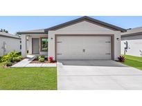 Charming single-story home with a two-car garage, landscaped yard, and inviting entrance at 4348 Deltona Blvd, Spring Hill, FL 34606