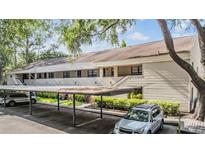 Inviting exterior shot of a condo building with covered parking and well-maintained landscaping at 4917 Puritan Cir # 105, Tampa, FL 33617
