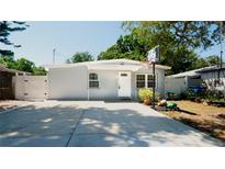 Charming single-story home with a well-manicured lawn, basketball hoop, and a long driveway at 7428 36Th N Ave, St Petersburg, FL 33710