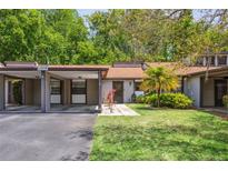 Charming single-story home with a covered parking and a cozy front yard and landscaping at 11536 Baywood Meadows Dr # 3, New Port Richey, FL 34654