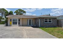 Charming single-story home featuring stucco and stone accents and a wide driveway at 119 18Th Nw St, Ruskin, FL 33570