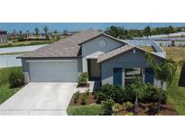 Charming single-story home featuring a two-car garage, manicured landscaping, and neutral-toned exterior at 13506 Wild Ginger St, Riverview, FL 33579