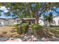 Charming home with a manicured yard and large tree providing ample shade at 1610 15Th N St, St Petersburg, FL 33704