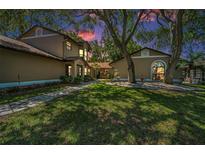 Charming home with lush landscaping, mature trees, and a welcoming entrance for great curb appeal at 1647 Hamilton Ct, Dunedin, FL 34698