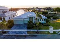 Charming waterfront home boasting lush landscaping, a paver driveway, and a durable metal roof at 5603 Tybee Island Dr, Apollo Beach, FL 33572
