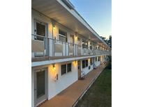 Well-lit two-story building exterior featuring walkways, balconies, and exterior lighting at 5940 21St N St # 11, St Petersburg, FL 33714