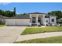 Charming single-story home featuring a 3-car garage and well-maintained landscaping at 8406 Glengarry Pl, Trinity, FL 34655